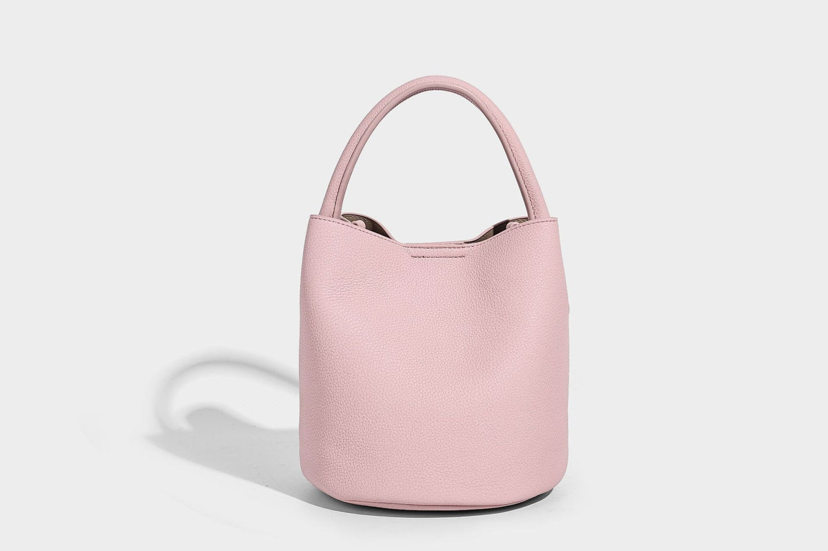 Mini pebbled leather-look bucket bag with front buckle strap, silver-tone hardware, top handle, and detachable shoulder