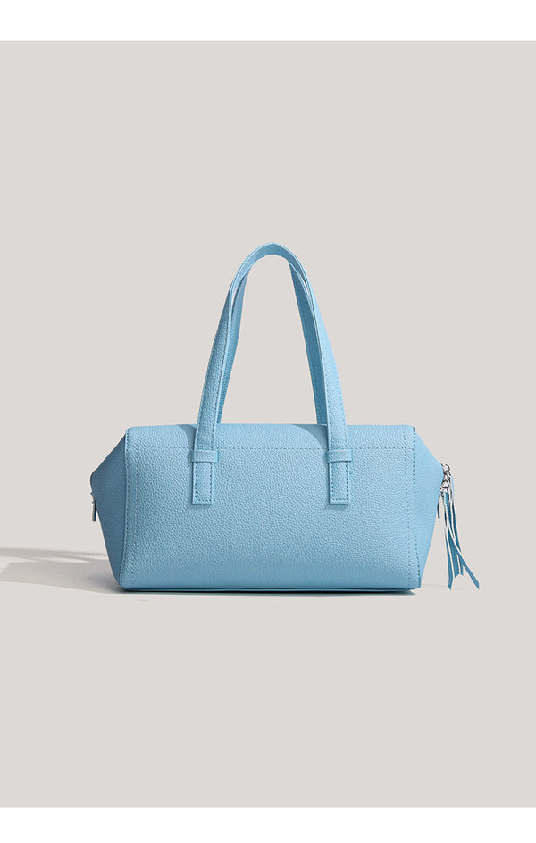 Light blue pebbled matte Boston tote bag with top handles, detachable shoulder strap, metal ring hardware, and matching mini