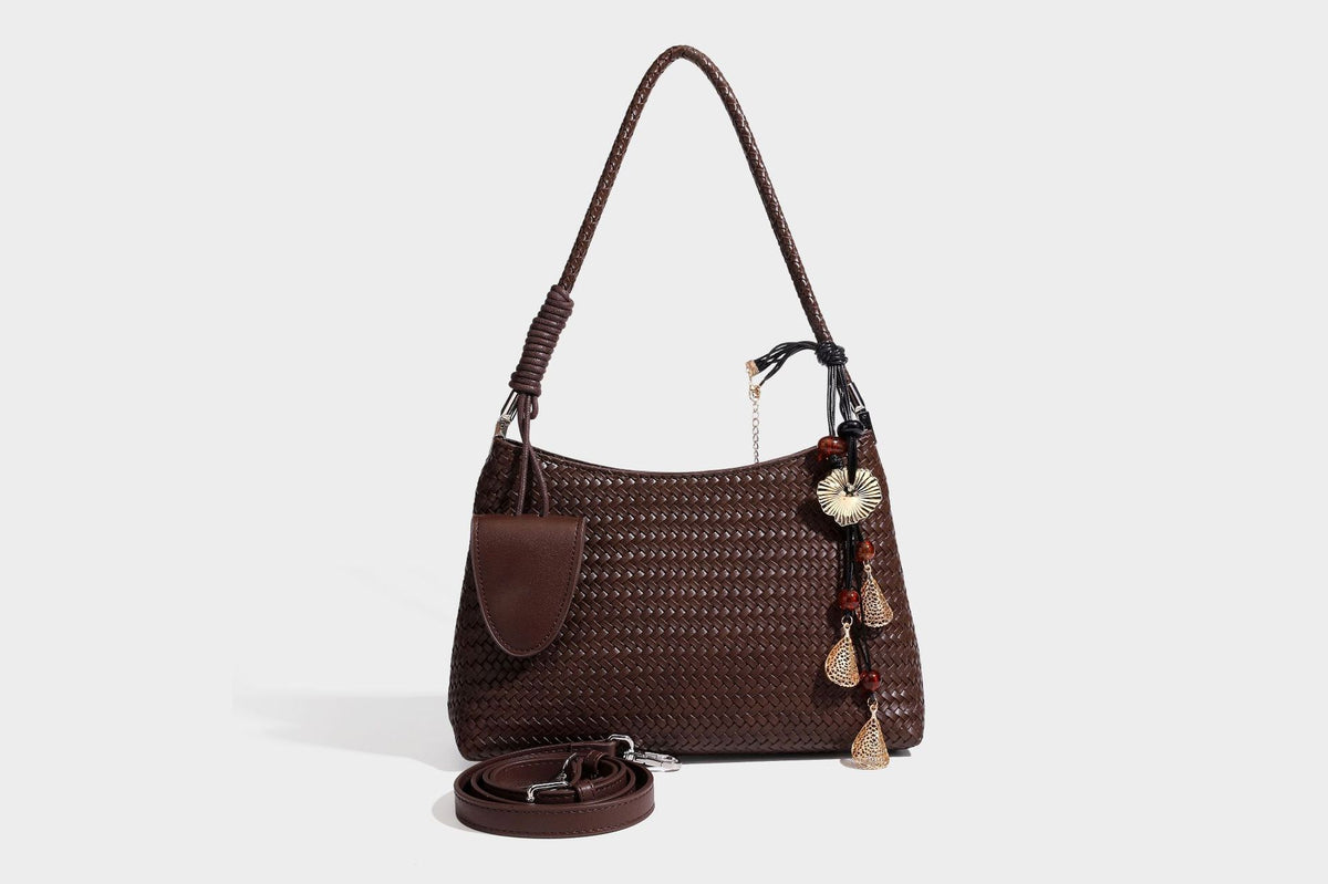 Woven-texture hobo shoulder bag in brown with braided top handle, adjustable crossbody strap, front flap pocket, and, detail