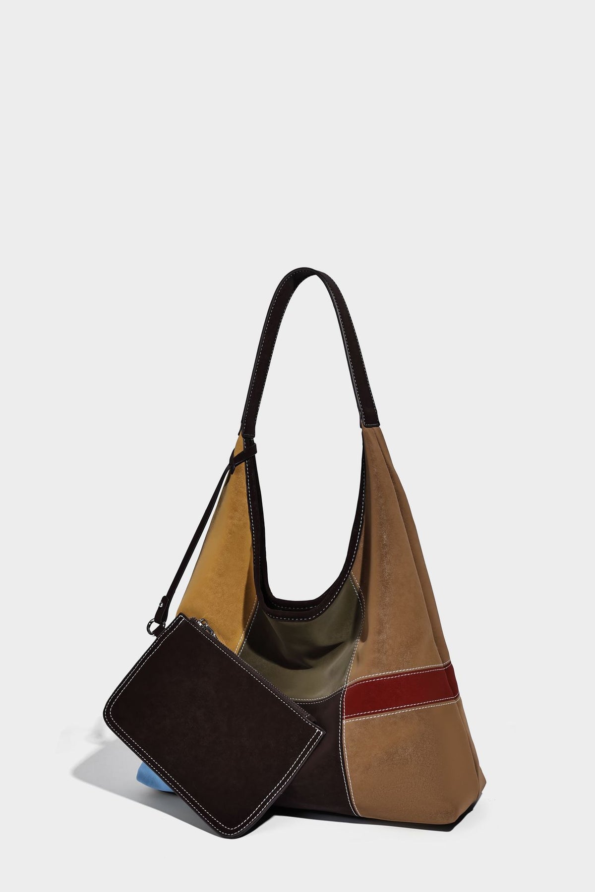 Multicolor patchwork hobo shoulder bag with brown tan olive mustard red and blue suede-look panels, contrast white stitching