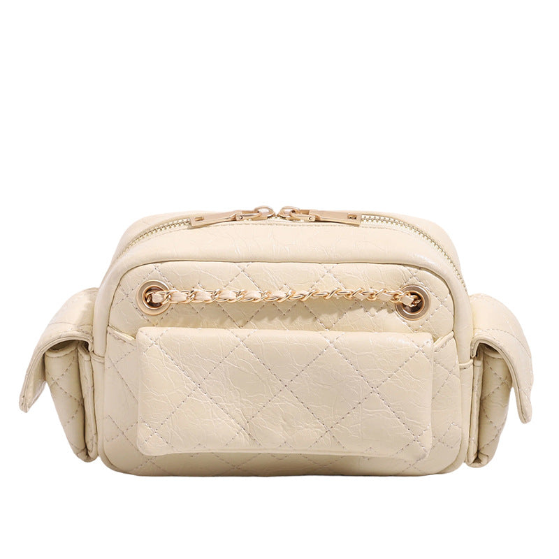 Compact quilted diamond-stitch crossbody bag with gold-tone chain strap and top zip closure, detail view 5