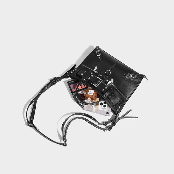 Black structured rectangular satchel bag with silver-tone rivets, large front buckle strap, zip pockets, dual top handles