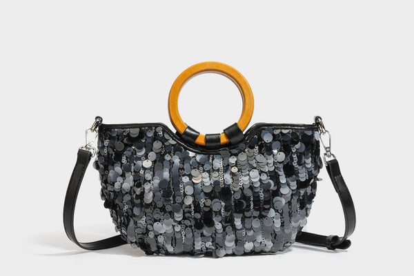Small sequin half-moon handbag with circular wood-look ring handles and detachable leather-look shoulder strap, detail view