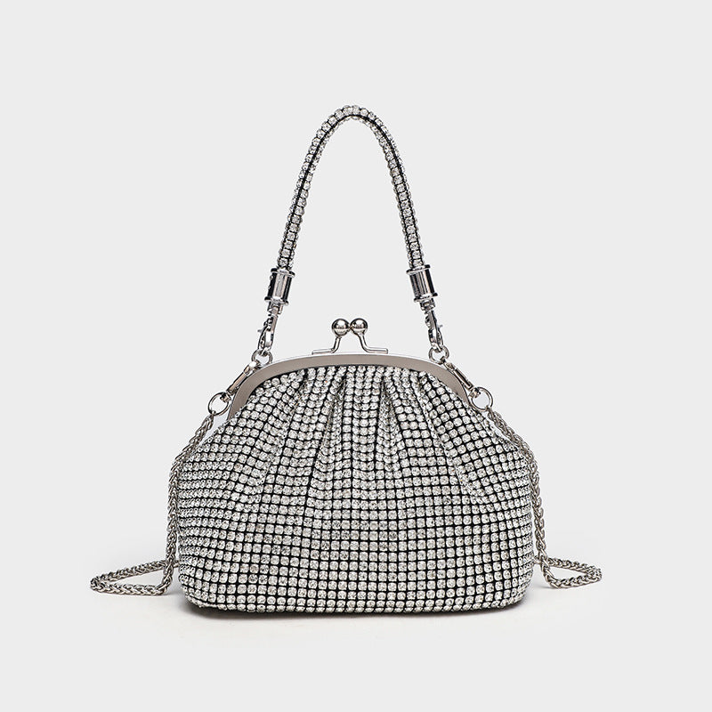 Compact all-over rhinestone kiss-lock evening bag with silver-tone metal frame, rhinestone top handle, and detachable chain