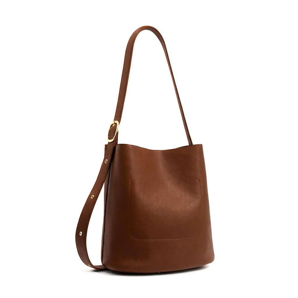 Pebbled textured bucket bag with gold-tone kiss-lock front pocket and adjustable single shoulder strap, detail view 17
