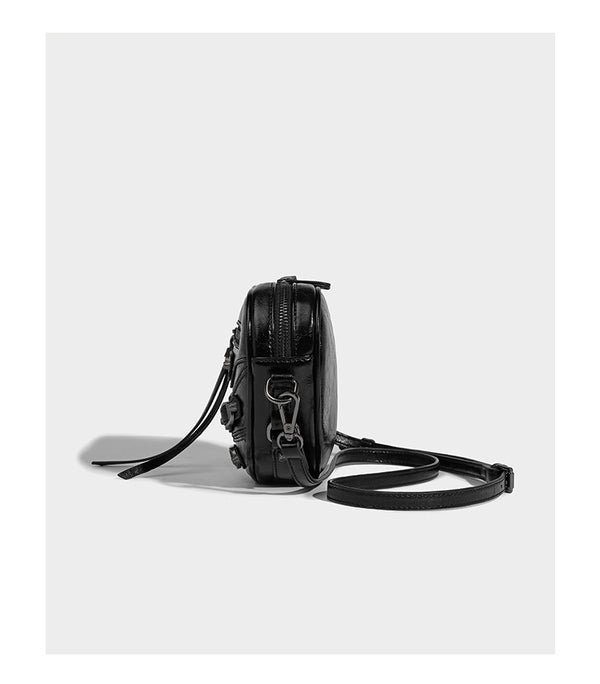 Mini heart-shaped crossbody bag with glossy crinkled finish and moto buckle hardware, detail view 12