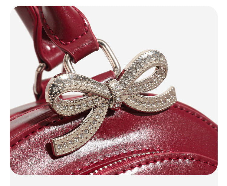 Structured half-moon mini handbag with silver-tone crystal bow hardware and star charm chain, detail view 12