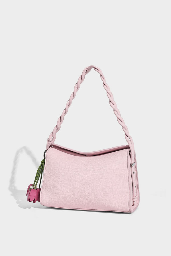 Small structured pebbled-finish shoulder bag with braided top handle, detachable crossbody strap, floral tassel charm, and