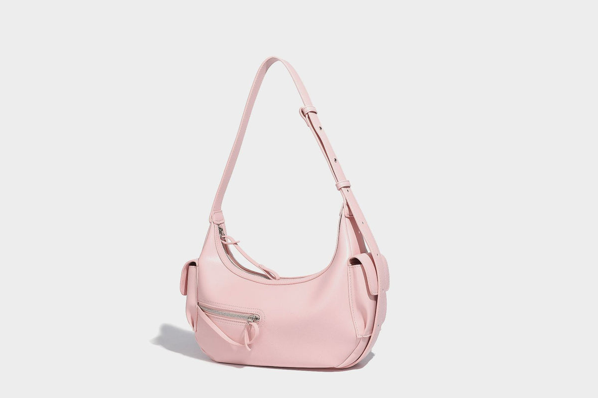 Smooth leather-look crescent shoulder bag with front zip pocket, side flap pockets, adjustable strap, and silver-tone, detail