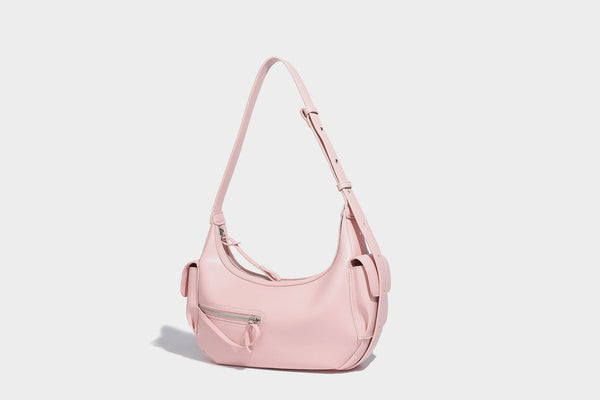 Smooth leather-look crescent shoulder bag with front zip pocket, side flap pockets, adjustable strap, and silver-tone, detail