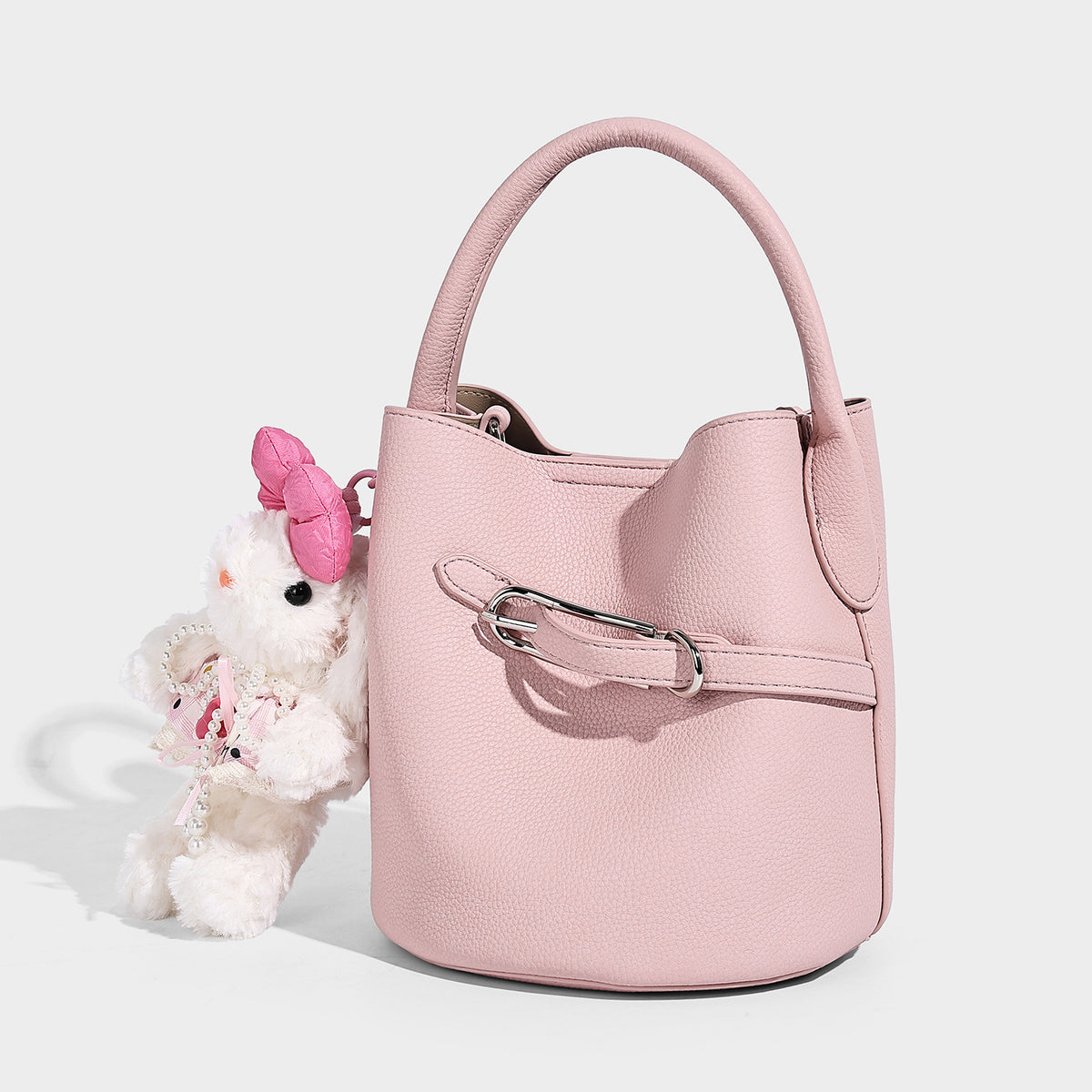 Mini pebbled leather-look bucket bag with front buckle strap, silver-tone hardware, top handle, and detachable shoulder