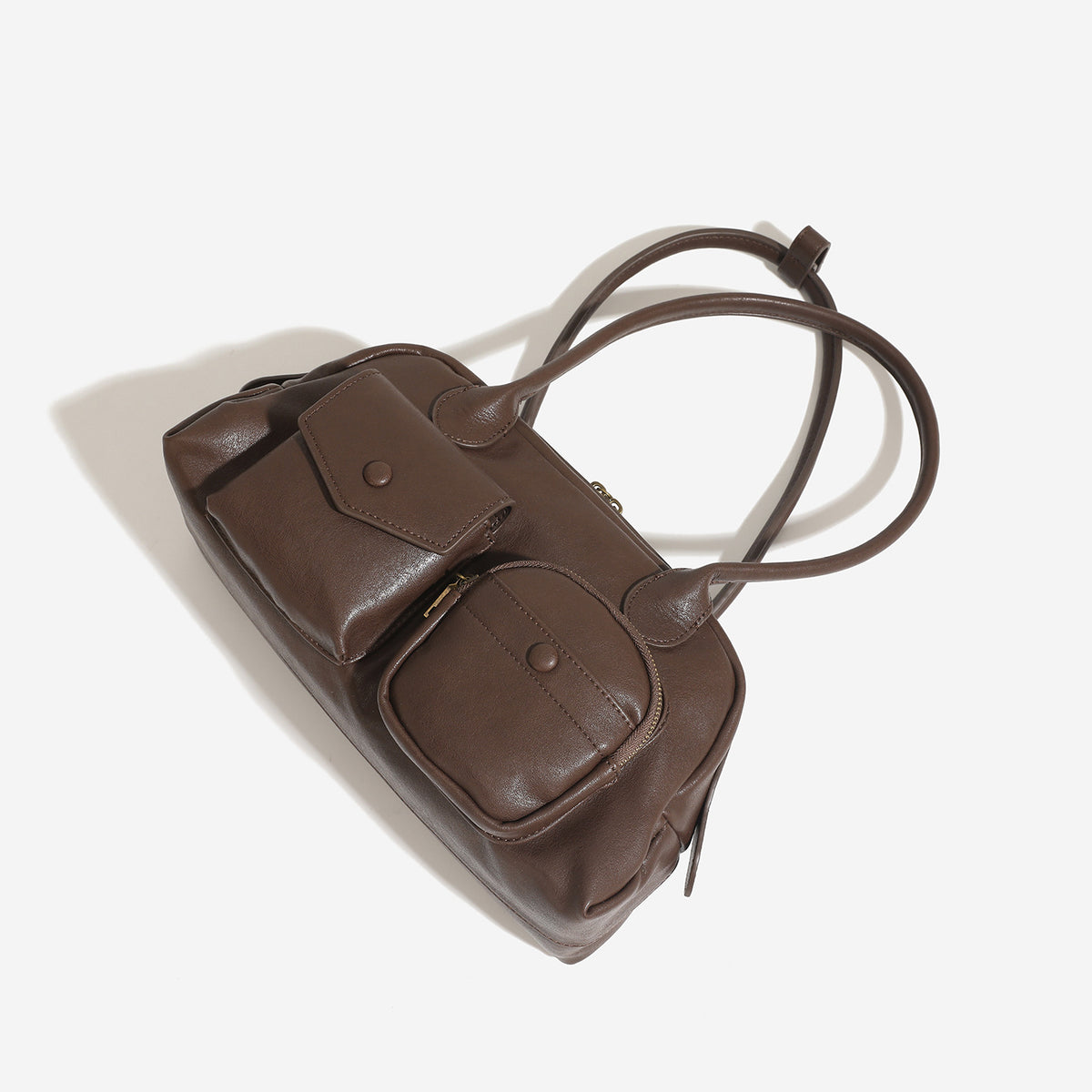 Structured retro bowling-style top-handle handbag with dual zip closure, front snap-flap pocket, and front zip pocket, detail