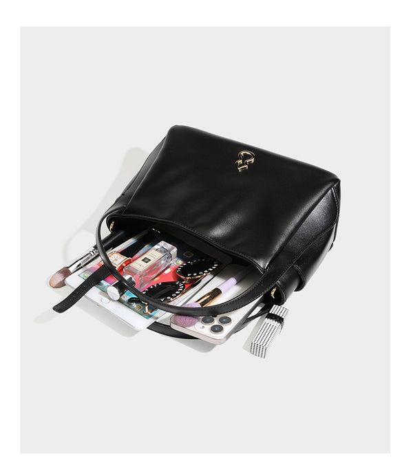 Structured glossy leather-look tote shoulder bag with dual top handles, detachable crossbody strap, side pockets, and, detail