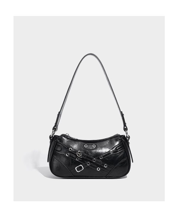 Compact moto-inspired shoulder bag with crisscross grommet strap detail, glossy textured finish, and adjustable crossbody