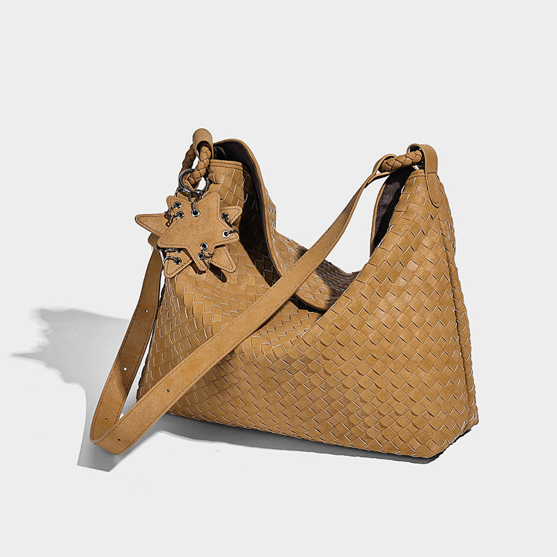Large soft woven hobo shoulder bag with matte textured finish, adjustable strap, and star charm hardware, detail view 16