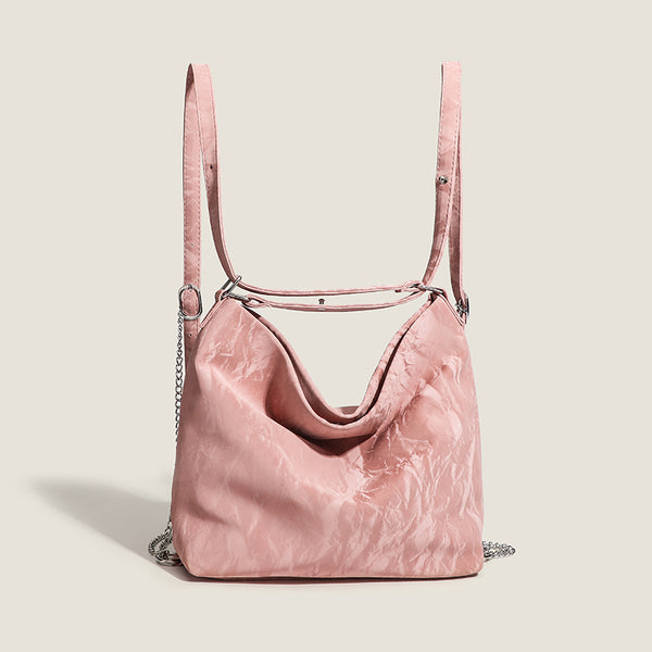 Blush pink slouchy hobo bag with crinkled sheen finish, silver-tone chain hardware, and adjustable shoulder strap, detail