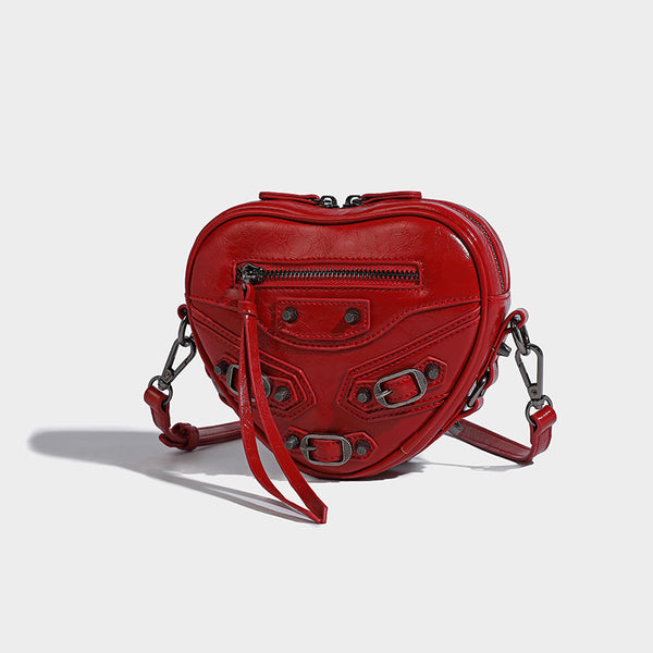 Mini heart-shaped crossbody bag with glossy crinkled finish and moto buckle hardware, detail view 3