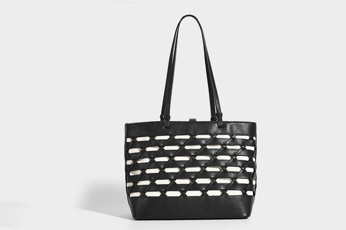 Structured woven lattice cutout tote bag with smooth leather-look trim, dual shoulder straps, and silver-tone hardware