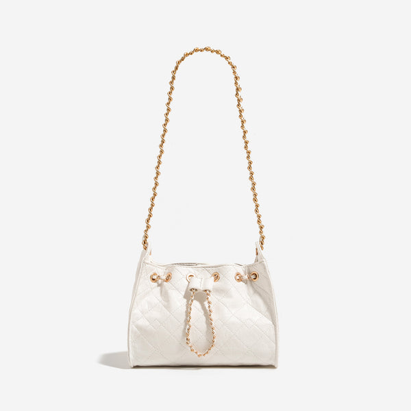 Glossy diamond-quilted drawstring bucket bag with gold-tone chain strap and eyelet hardware, detail view 8