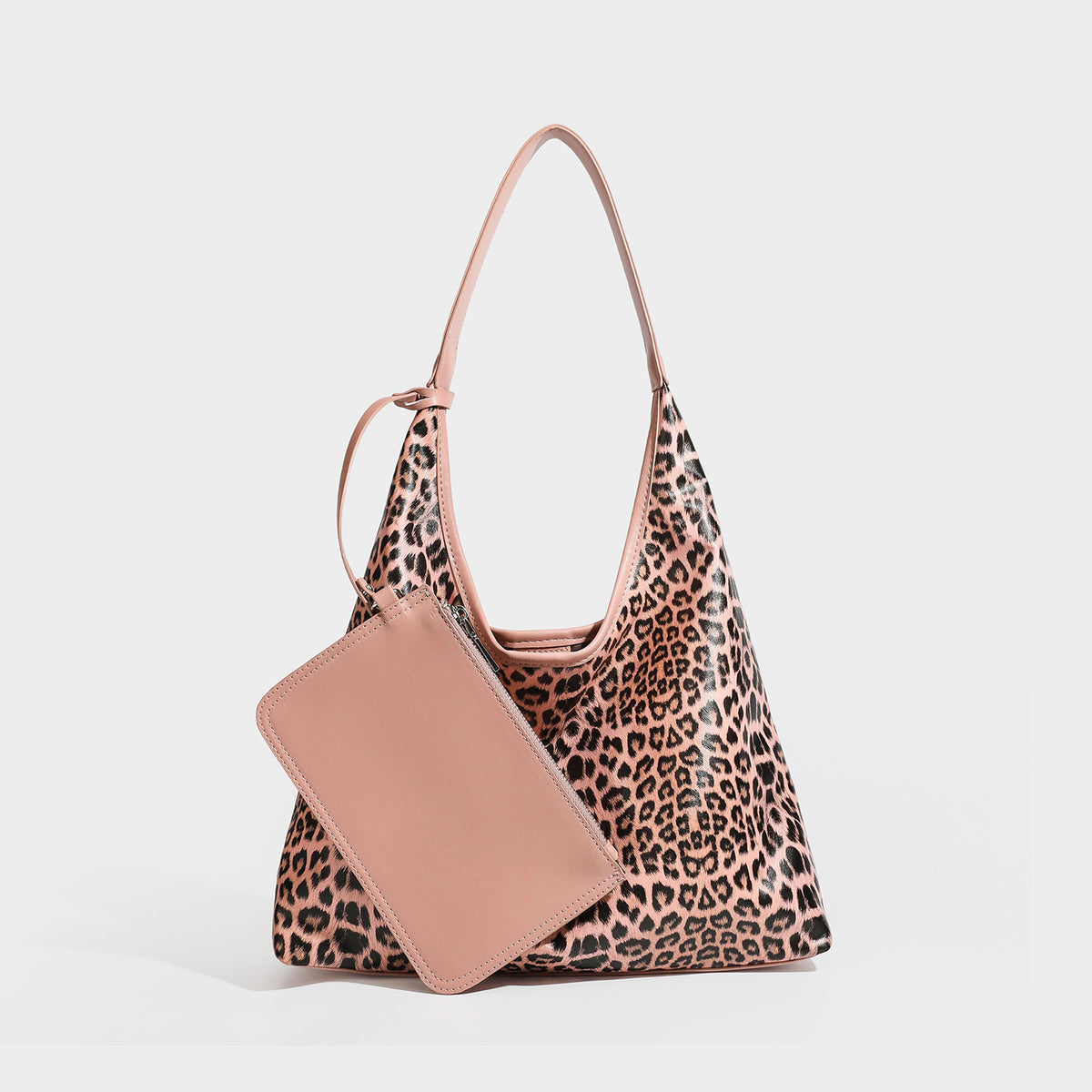 Glossy leopard-print slouchy shoulder bag with long strap and detachable tan zip pouch, detail view 2