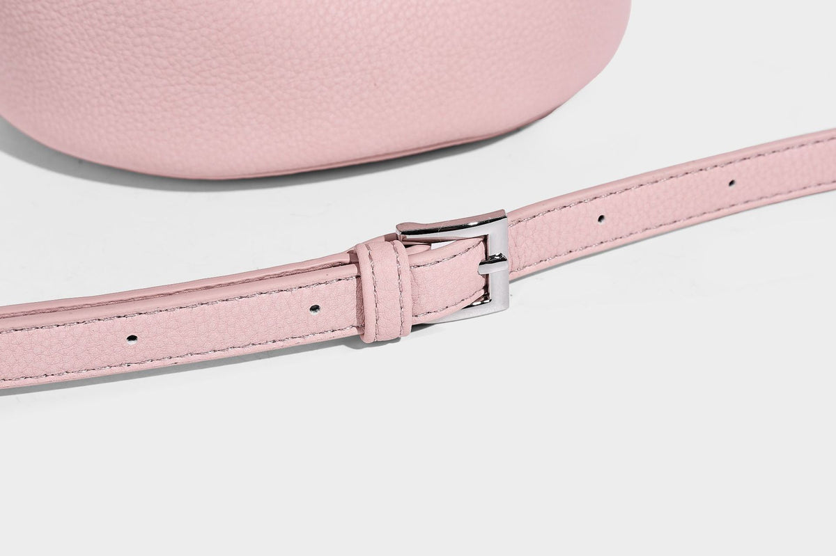 Mini pebbled leather-look bucket bag with front buckle strap, silver-tone hardware, top handle, and detachable shoulder