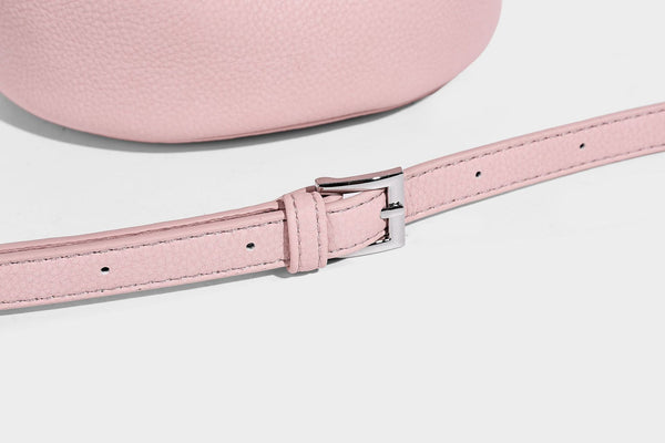 Mini pebbled leather-look bucket bag with front buckle strap, silver-tone hardware, top handle, and detachable shoulder