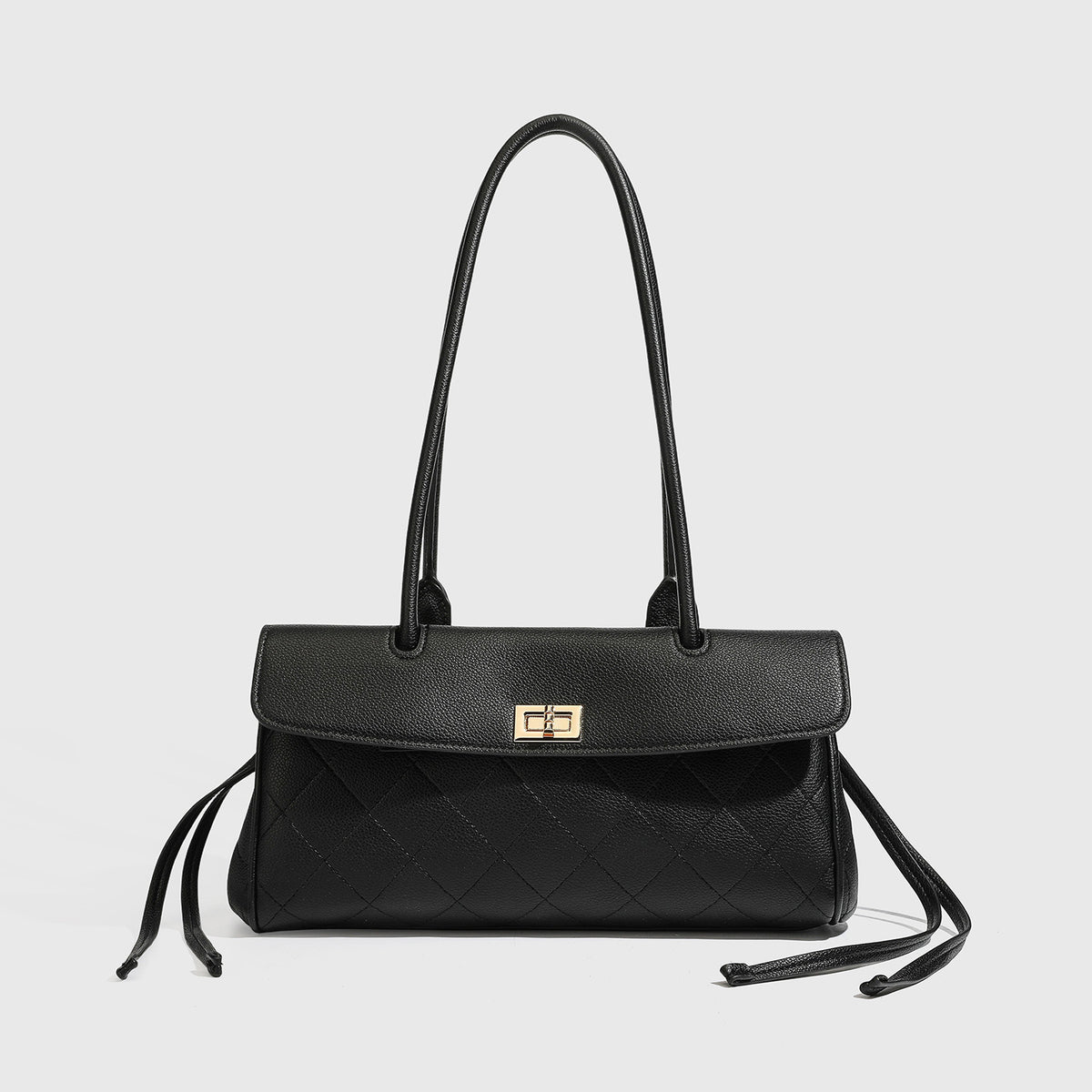 Structured black diamond-quilted shoulder bag with gold-tone turn-lock flap closure and dual round shoulder straps, detail