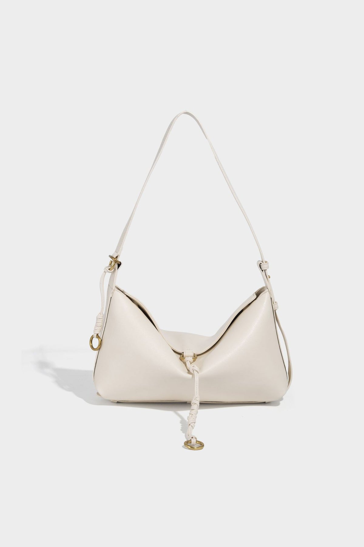 Slouchy brown leather-look shoulder bag with knotted drawcord tie closure, gold-tone ring hardware, and long adjustable