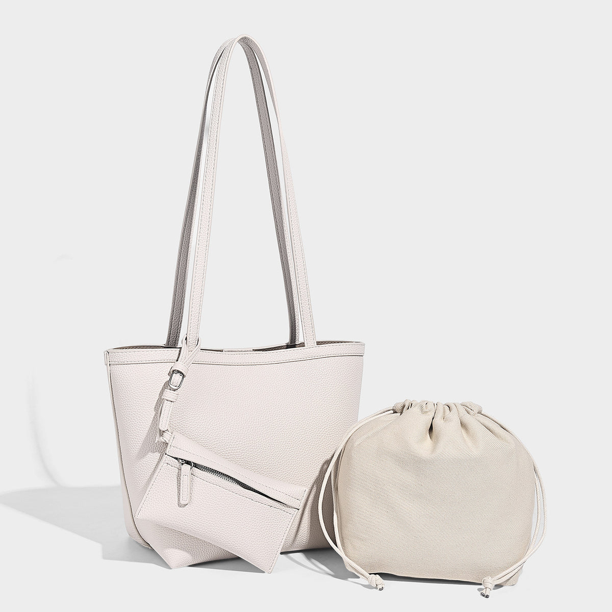 Structured pebbled leather-look tote bag in taupe with long shoulder strap, detachable zip pouch, and pink tulip flower