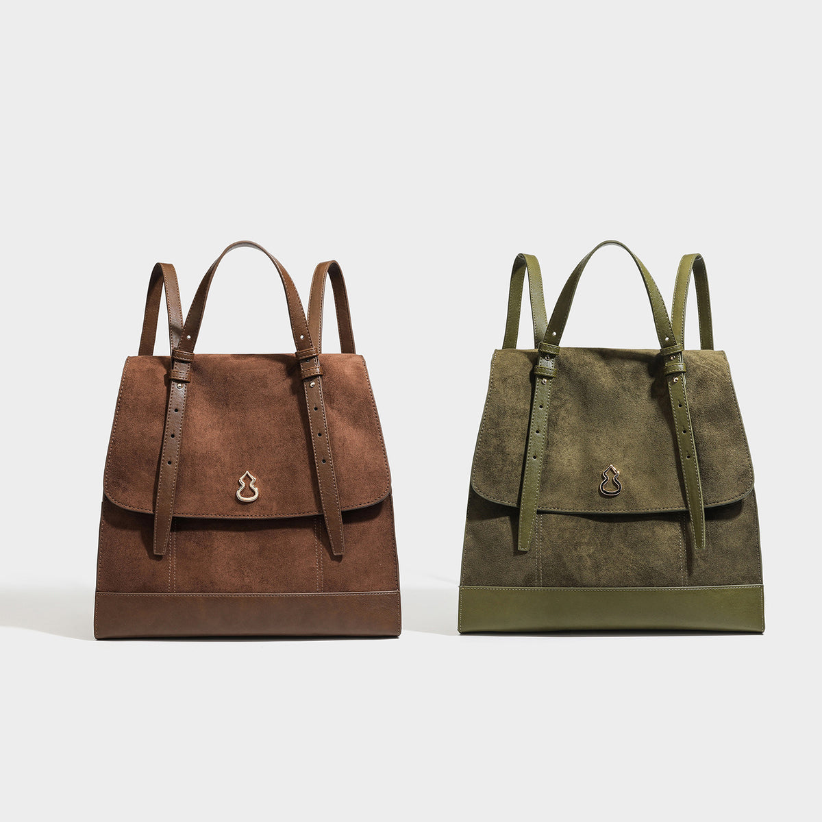 Structured suede-look convertible backpack handbag with flap closure and gold-tone emblem hardware in chocolate brown, detail