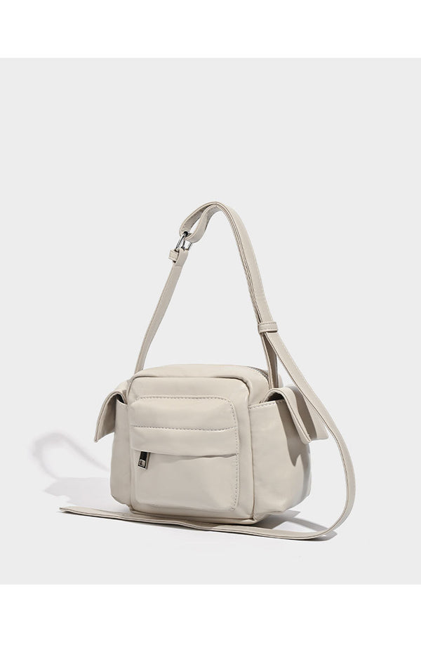 Boxy leather-look crossbody bag with front zip pockets, top zip closure, and long adjustable strap, detail view 11