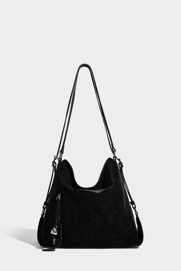 Slouchy hobo tote bag with matte leather-look finish, triangular silhouette, front zip pocket, and adjustable shoulder strap
