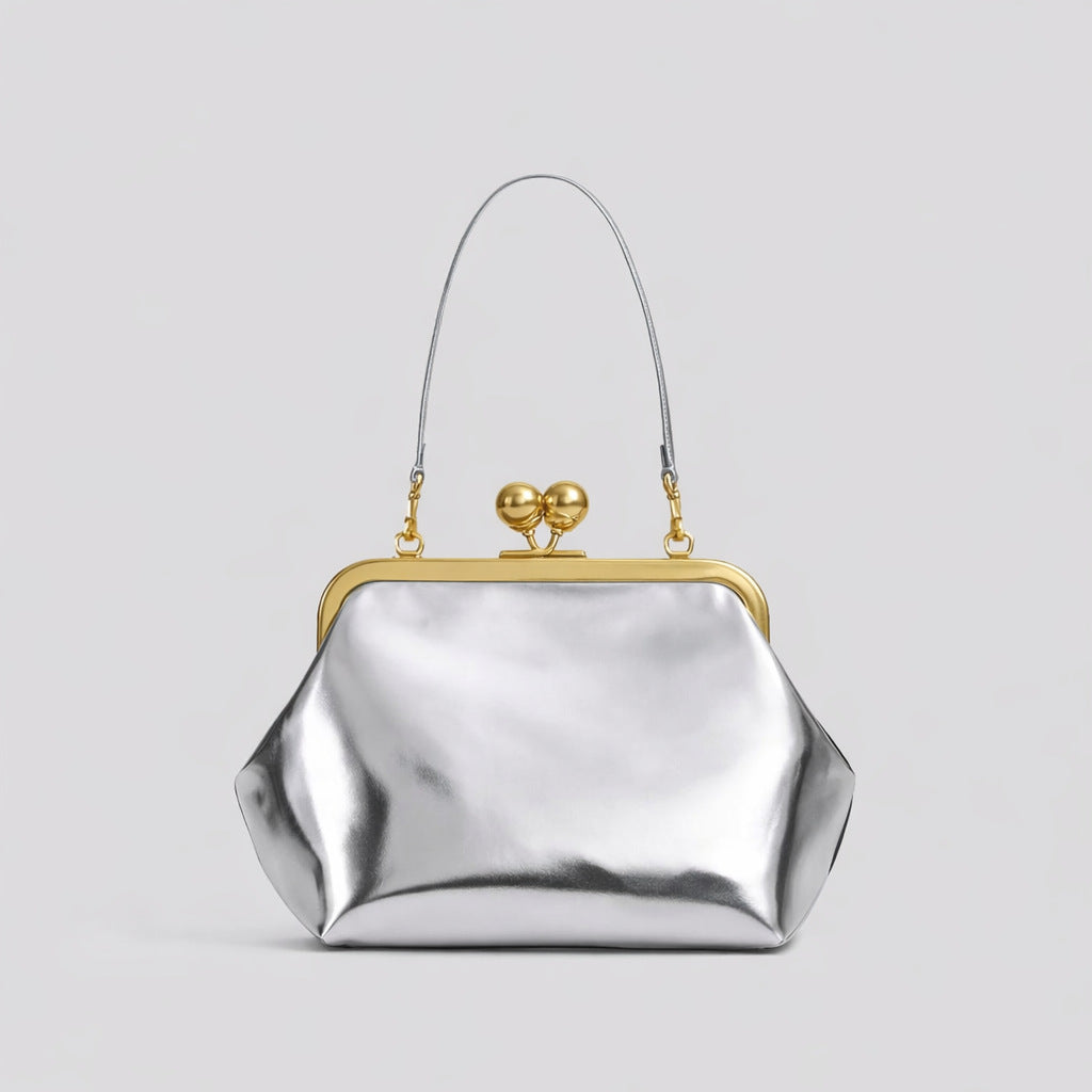 Oversized kiss-lock frame handbag with gold-tone metal clasp and smooth leather-look finish, detail view 14