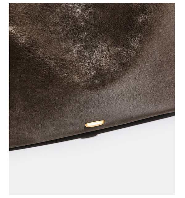 Large slouchy hobo tote bag in distressed dark brown leather-look finish with long shoulder strap, gold-tone ring hardware