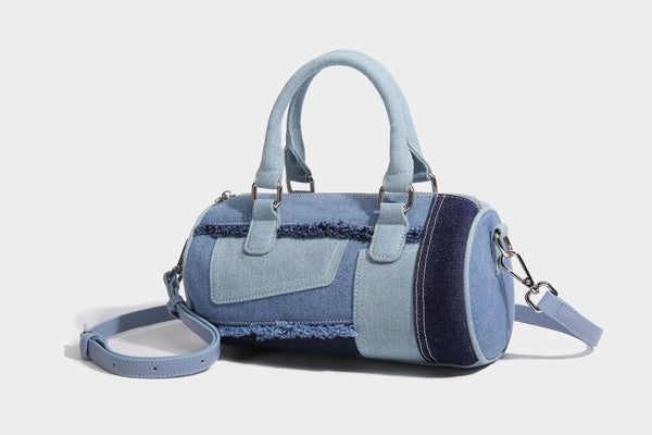 Mini barrel handbag in light and dark denim patchwork with frayed seam trim, dual top handles, top zip closure, and, detail