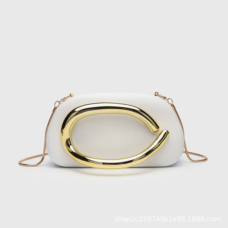 Kleine rechteckige Crossbody-Clutch mit abgerundeten Ecken, oversized poliertem C-förmigem Goldgriff und schmalem Goldkettenriemen, Detailansicht