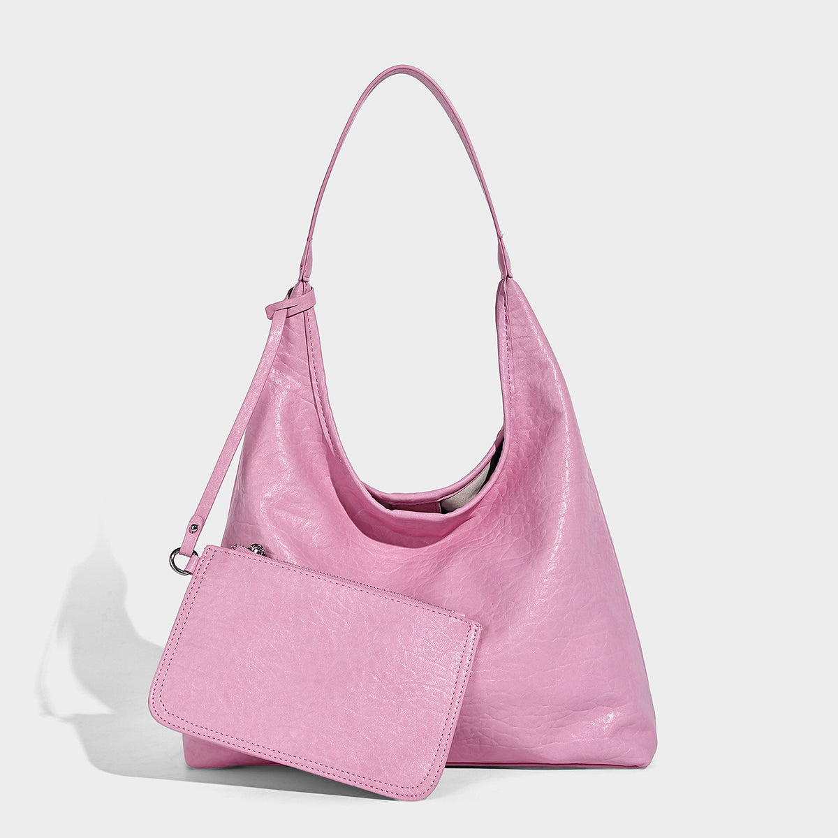 Slouchy hobo shoulder bag in pale yellow glossy pebbled leather-look finish with single shoulder strap and detachable front