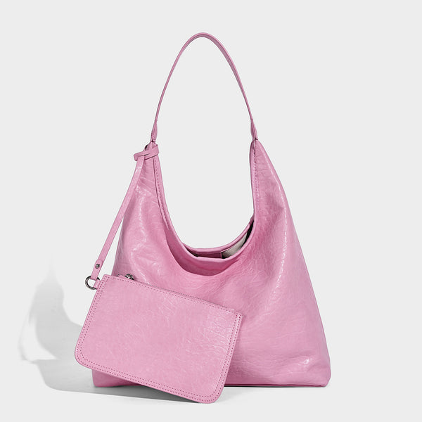 Slouchy hobo shoulder bag in pale yellow glossy pebbled leather-look finish with single shoulder strap and detachable front