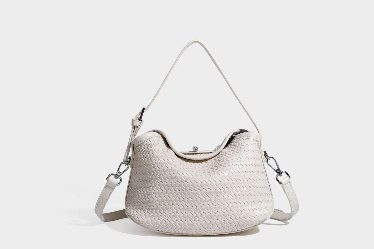 Small woven-look leather-look flap shoulder hobo bag in burgundy with silver-tone hardware and decorative tassel charm