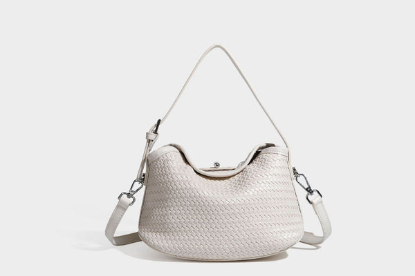 Small woven-look leather-look flap shoulder hobo bag in burgundy with silver-tone hardware and decorative tassel charm