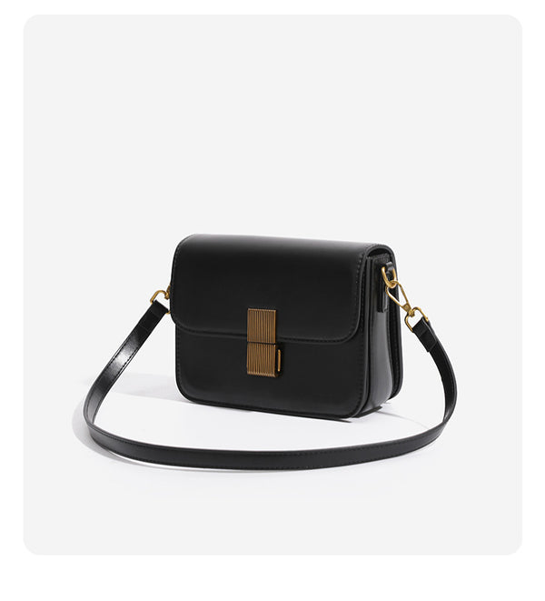 Mini structured black flap crossbody bag with gold-tone ribbed rectangular clasp and adjustable shoulder strap, detail view 8