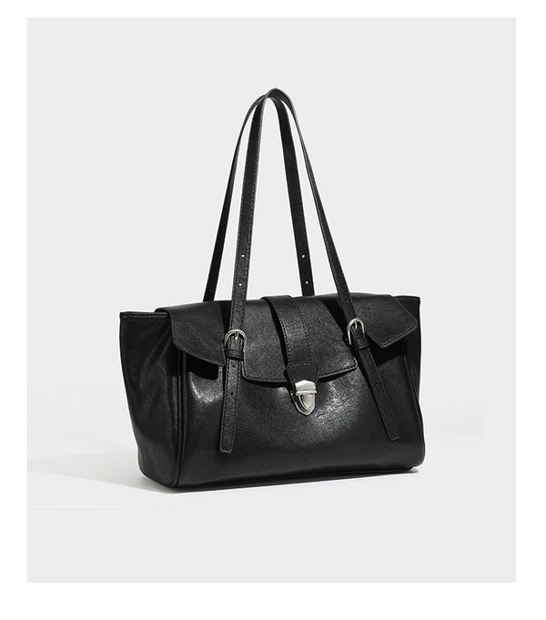Large structured vintage-style tote bag with flap-front turn-lock closure, twin buckle straps, and double shoulder handles