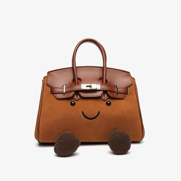 Small structured trapezoid satchel bag with smiling face motif, pom-pom accents, brown leather-look trim, silver-tone, detail