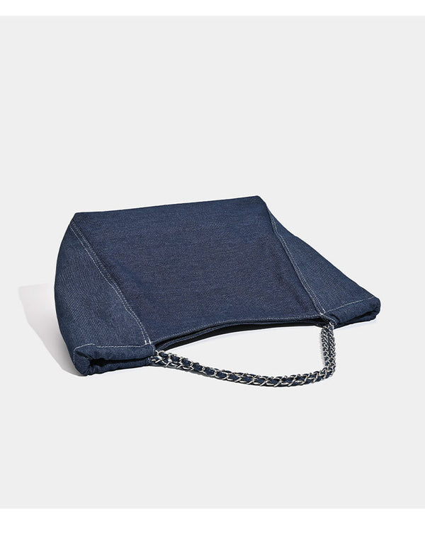 Large slouchy denim tote bag with silver-tone chain strap and contrast topstitching, detail view 10