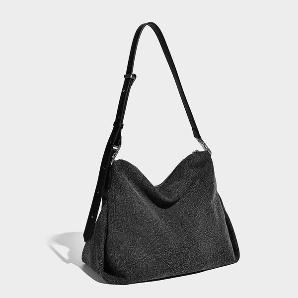 Charcoal denim-textured slouchy hobo bag with zip-top closure, silver-tone hardware, and adjustable leather-look crossbody