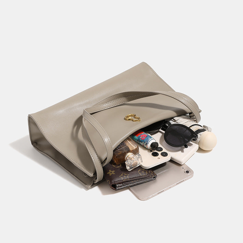 Smooth leather-look slouchy trapezoid shoulder tote with gold-tone gourd clasp hardware and long slim straps, detail view 3