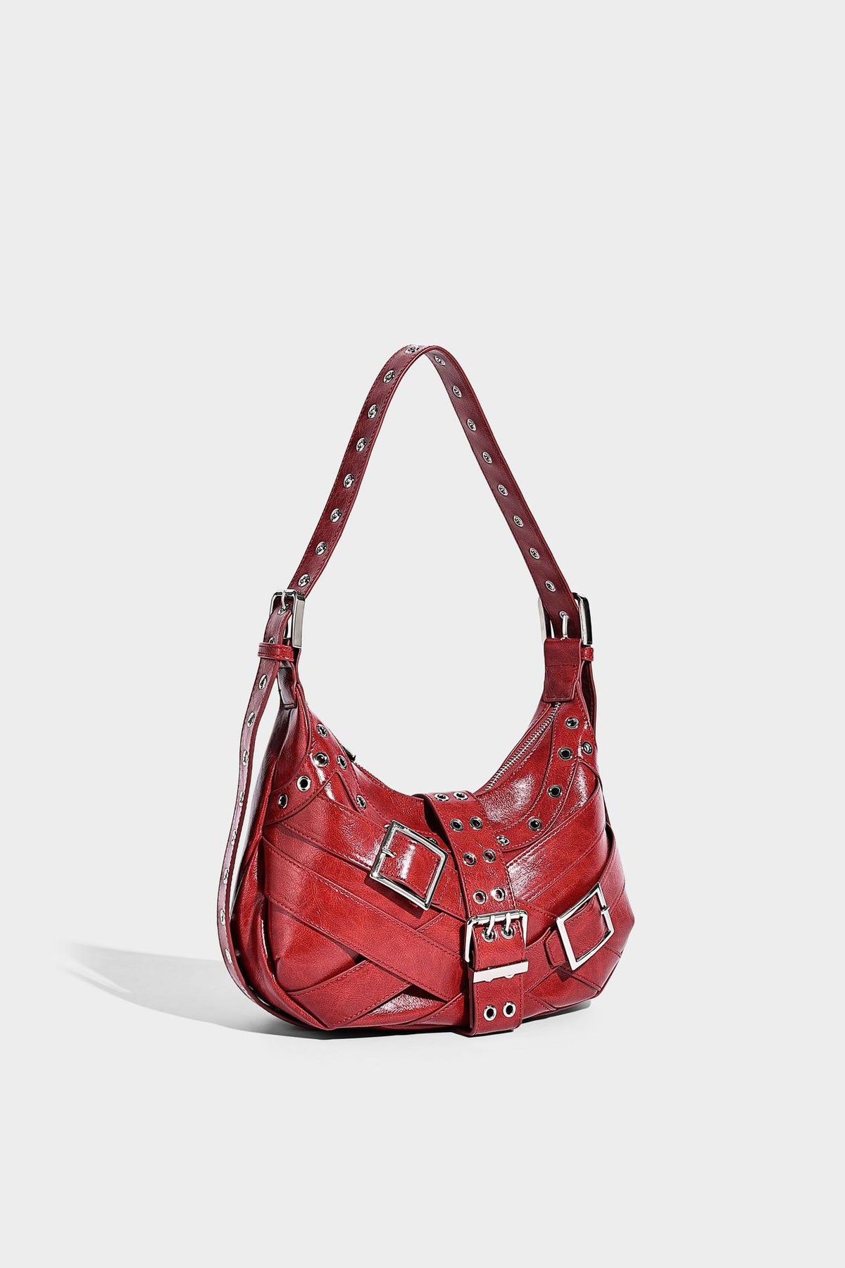 Glossy crescent hobo bag with silver-tone grommets, square buckle straps, and top zipper closure, detail view 11