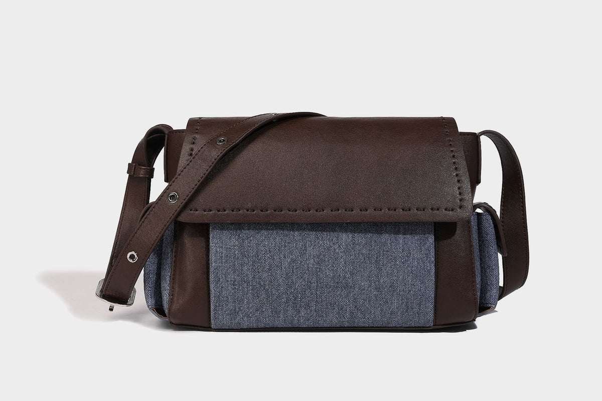 Structured flap crossbody bag in dark brown and cream color-block with white contrast stitching, adjustable shoulder strap