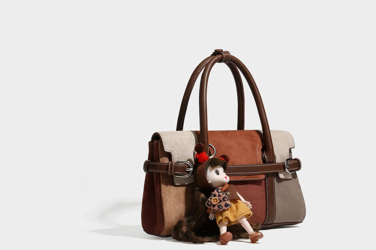 Structured color-block satchel bag in brown, rust, beige, and taupe suede-look panels with white topstitching, front buckle
