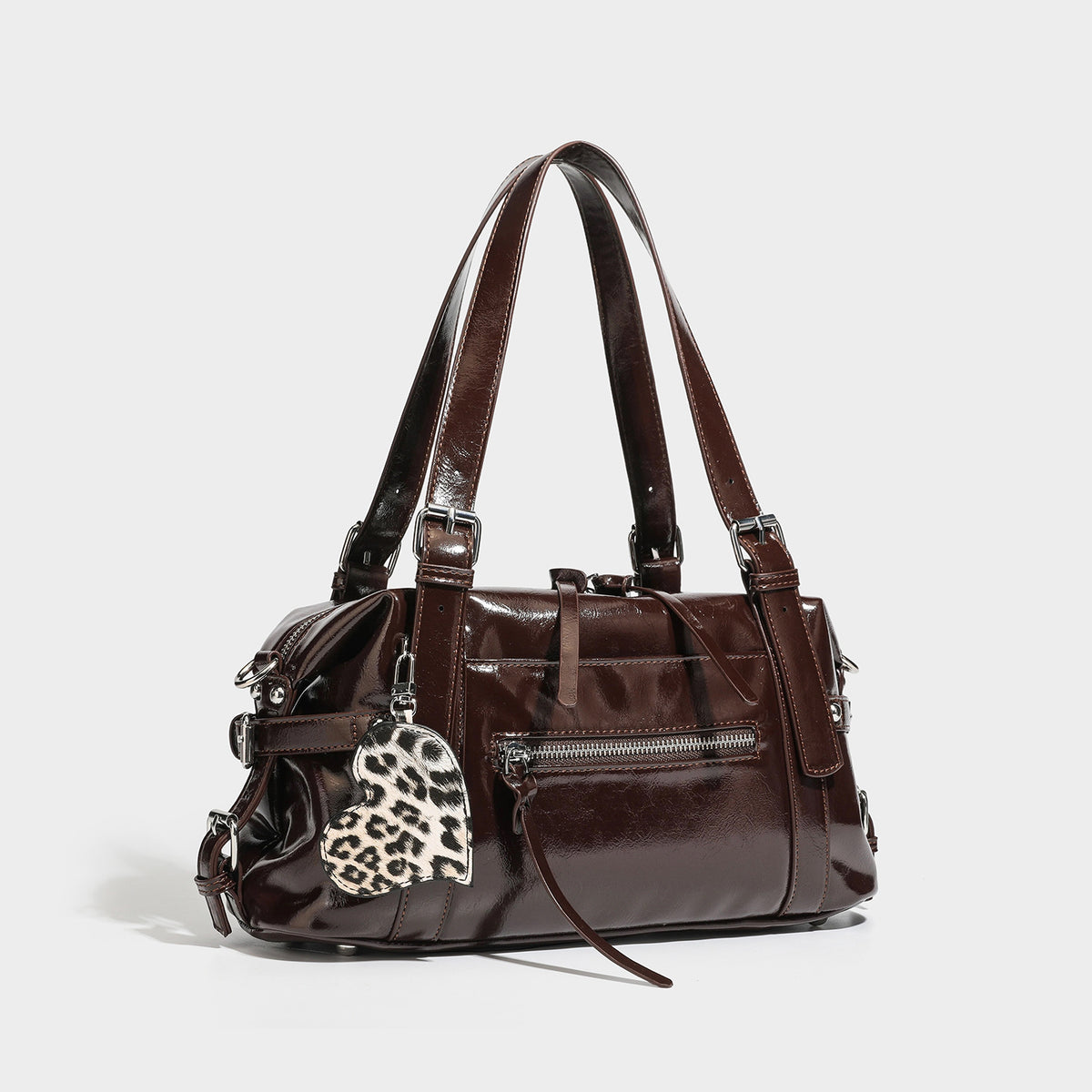 Structured glossy leather-look shoulder bag with rounded body, silver-tone hardware, front zip pocket, and leopard-print